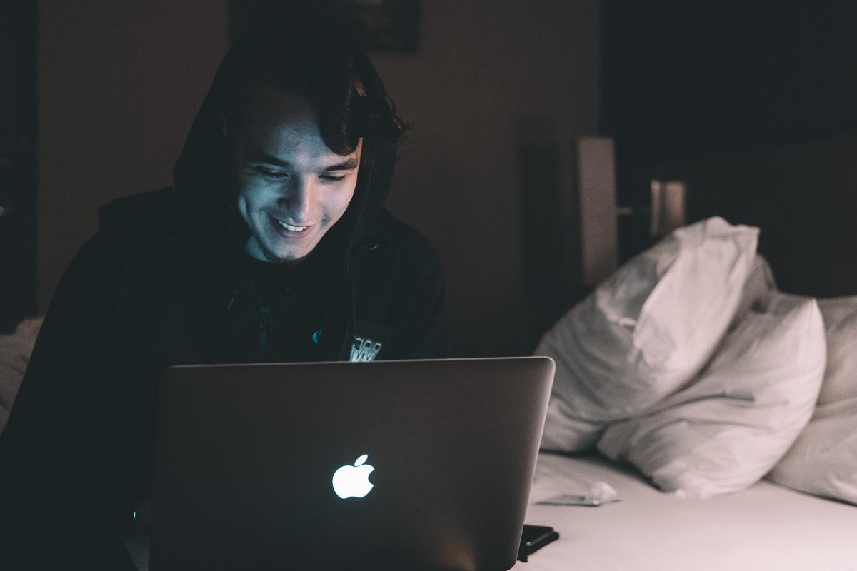 man smiling in front of computer best smile caption for facebook