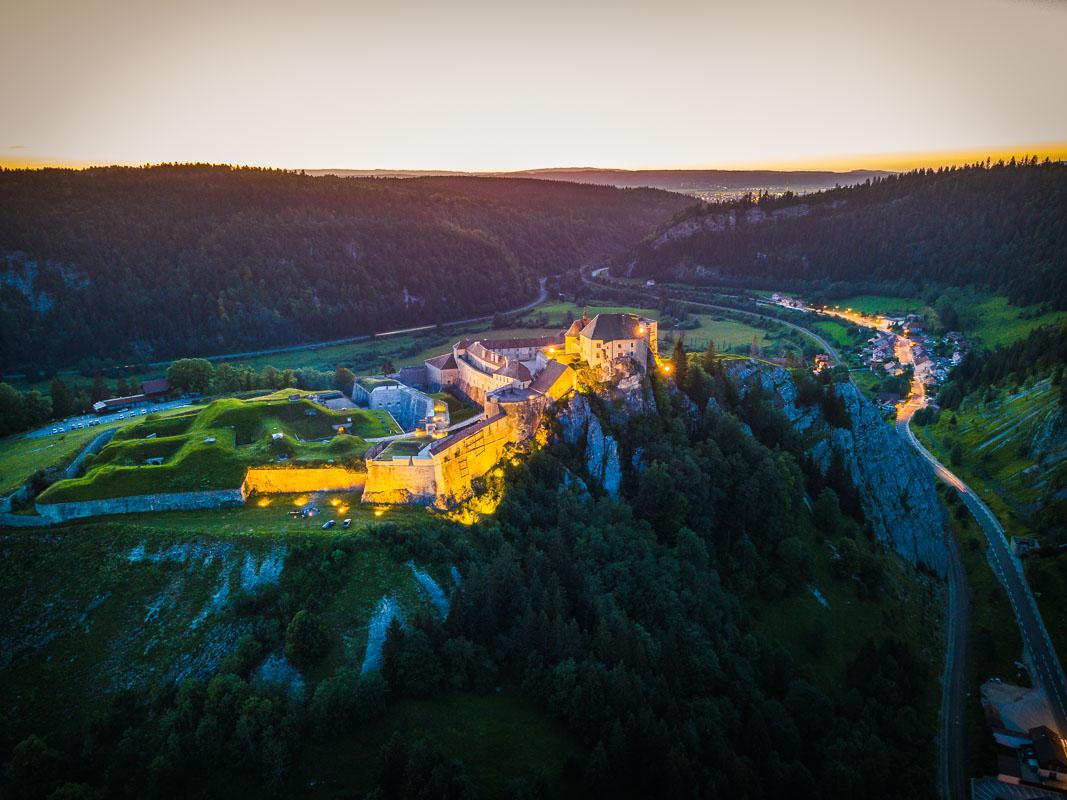 chateau de joux at night on the cliff