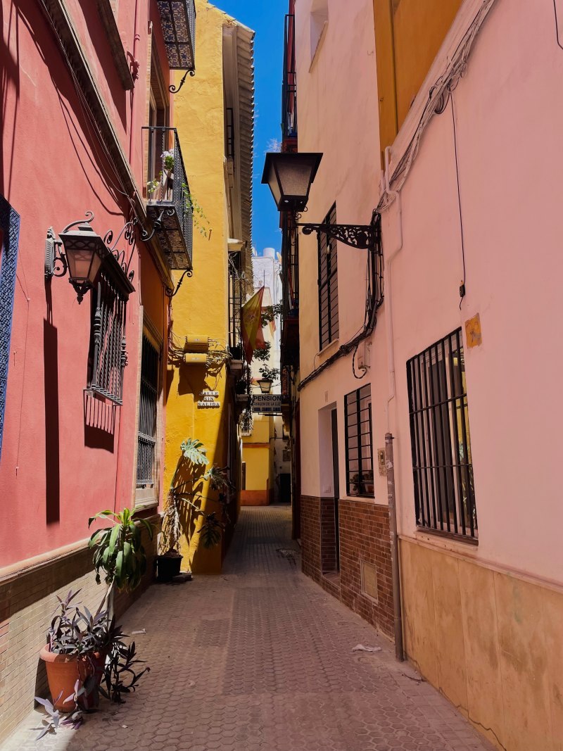 narrow orange and red street in seville old town